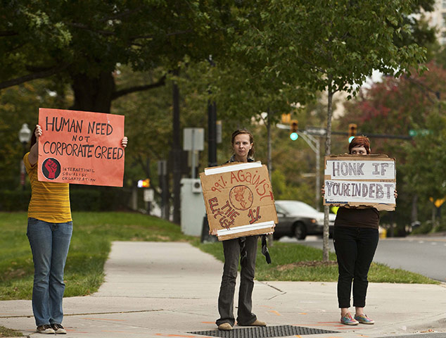 Occupy protests: Charlotte: Protesters with the occupy movement hold up signs