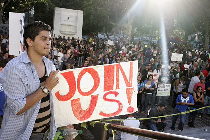 Occupy protests: Los Angeles: A demonstrator holds a sign at the Occupy LA protest 