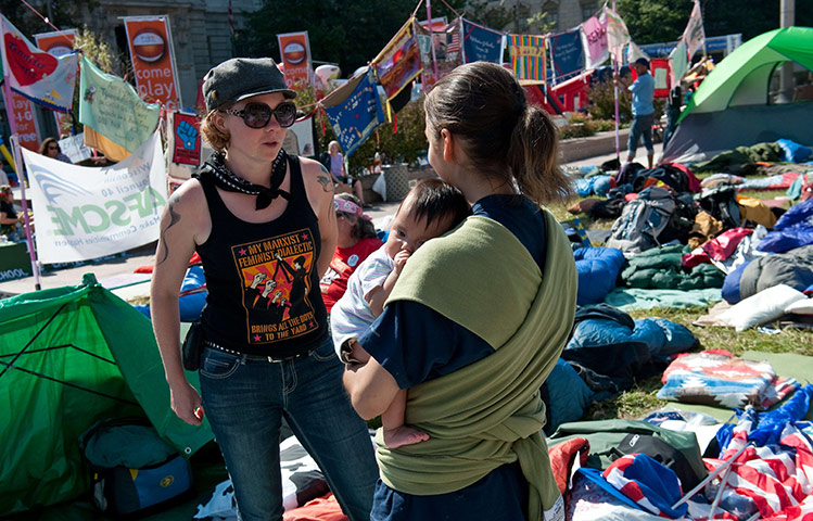 Occupy protests: Washington: Two women speak among tents and sleeping bags at Freedom Plaza 