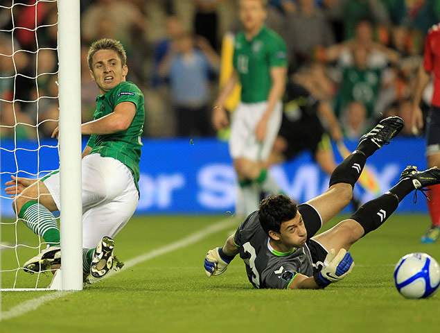 Euro 2012 Qualifiers: Kevin Doyle & Arsen Petrosyan look at the ball roll across the goal