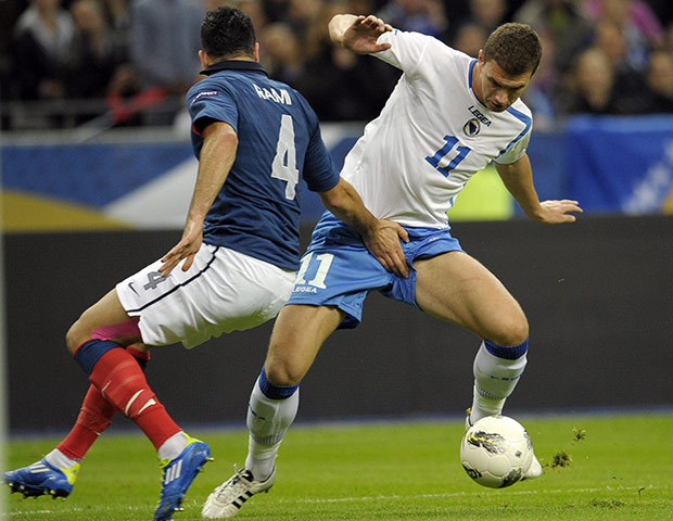 Euro 2012 Qualifiers: France's Adil Rami attempts to tackle Bosnia-Herzegovina's Edin Dzeko