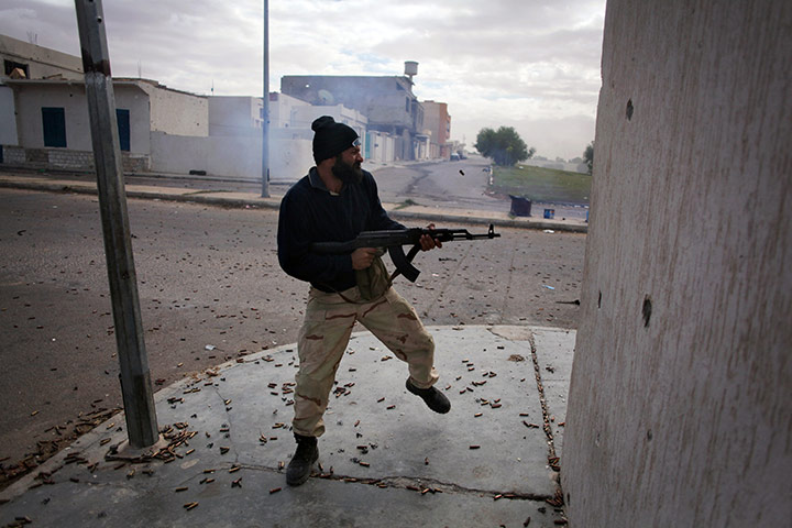From the agencies: Manu Brabo: A revolutionary fighter fires his weapon in Sirte