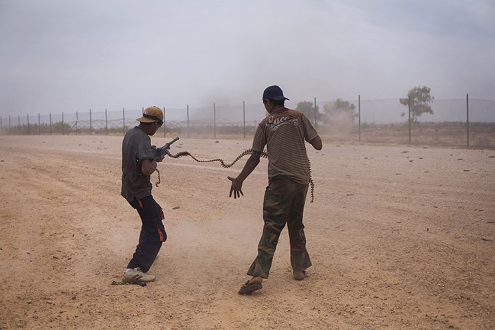 From the agencies: Manu Brabo: Libyan revolutionary fighters fire a machine gun 