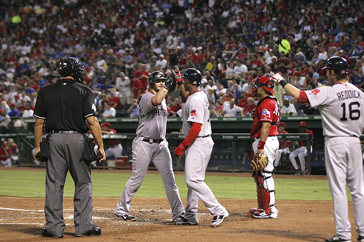 John Henry Timeline: Adrian Gonzalez #28 of the Boston Red Sox is congratulated by Carl Crawford