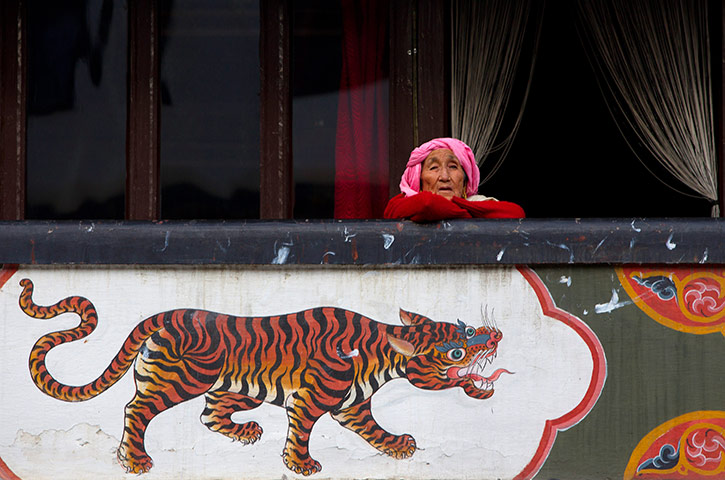 Bhutanese royal wedding: A woman looks out onto the street