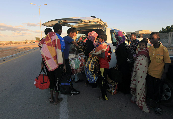 Sirte street battles: Families displaced from Sirte flee the fighting 