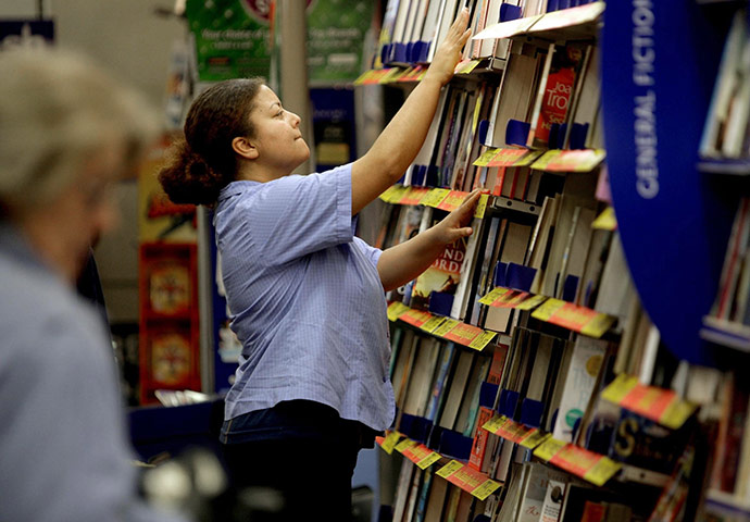 Week in Business: An employee fills book shelves at a WH Smith store in Bristol.