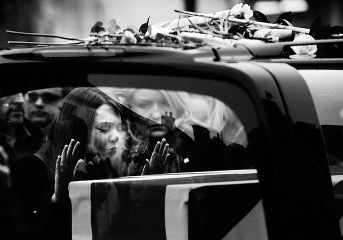 Wootton Bassett: A mourner kisses the hearse of Lieutenant Corporal Scott Hardy