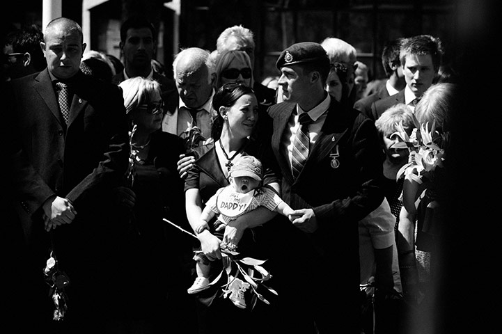 Wootton Bassett: The wife and child of Corporal Stephen Curley watch the cortege
