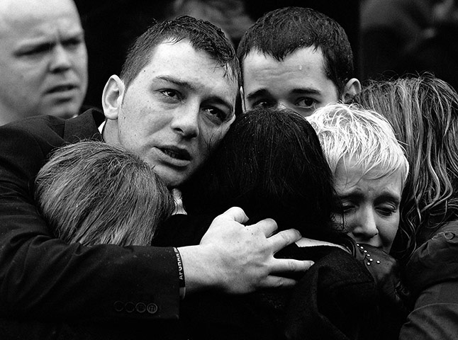 Wootton Bassett: Mourners watch the hearses carrying the coffins of five British soldiers