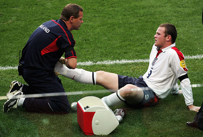 Rooney's tournament woes: Wayne Rooney receives treatment on his ankle in the Euro 2004 Quarter Final