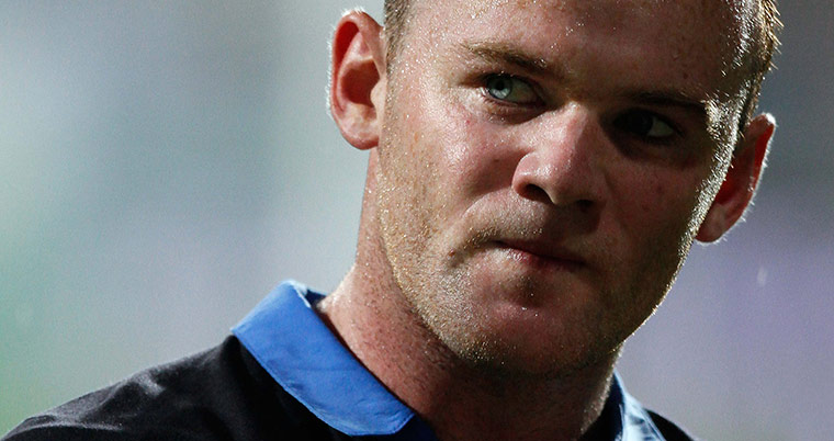 Rooney's tournament woes: Wayne Rooney leaves the field after receiving a red card against Montenegro