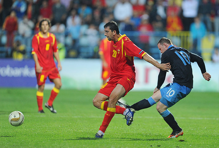 Rooney's tournament woes: Wayne Rooney kicks out at Miodrag Dzudovic of Montenegro and gets sent off