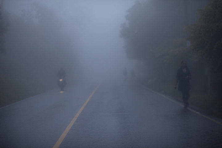 24 hours in pictures: Santa Rosa, Guatemala: A woman walks through dense fog