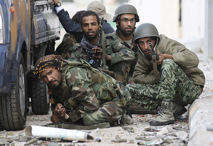 24 hours in pictures: Sirte, Libya: Anti-Gaddafi fighters take cover during fighting