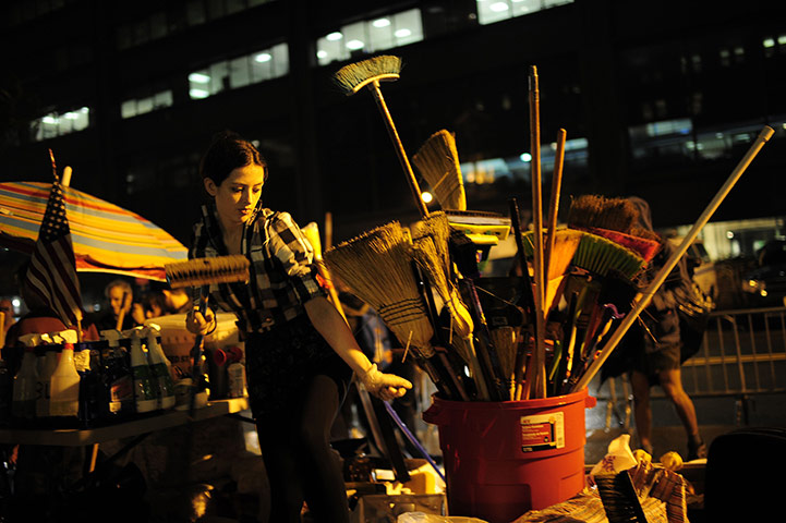 Occupy Wall Street: A member of Occupy Wall Street picks up a broom