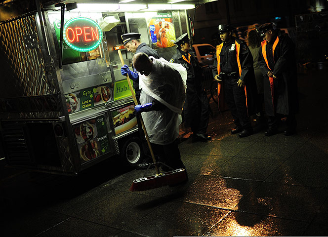 Occupy Wall Street: A protester sweeps the pavement