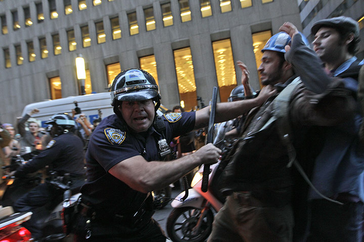 Occupy Wall Street: A New York City police officer shoves a demonstrator