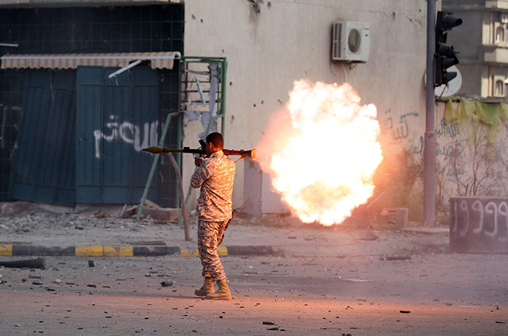 Libya, Sirte:  Libyan Rebel fighter fires an RPG, during the battle  in Sirte