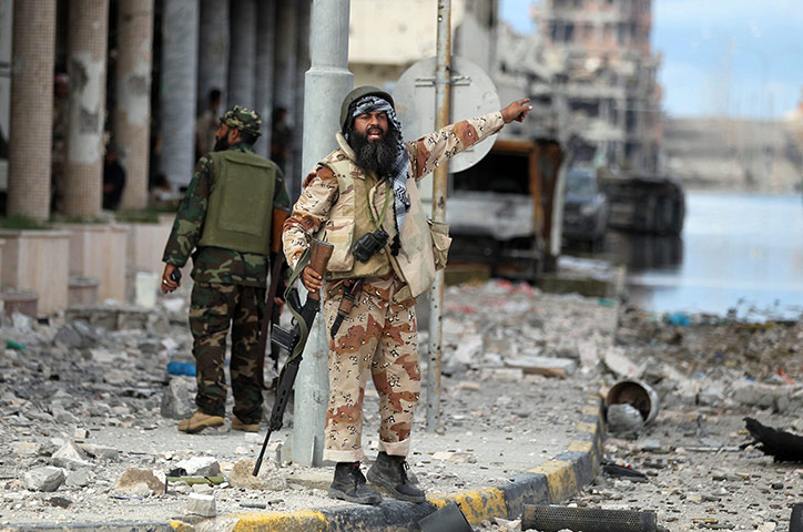 Libya, Sirte: A Libyan rebel gestures during the battle to liberate the city of Sirte