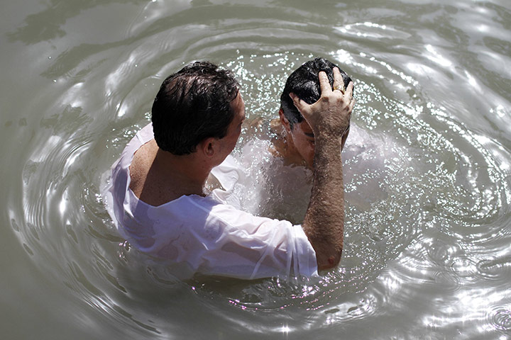 24 hours: Israel: Brazilian pilgrims take part in a baptism ceremony