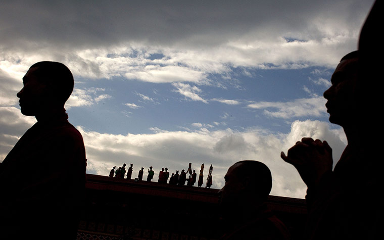 24 hours: Thimphu, Bhutan: Buddhist monks are silhouetted at the wedding of the King