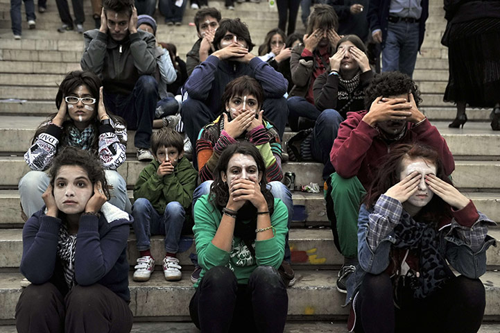 24 hours: Athens, Greece: Greek protesters cover their ears, mouth or eyes