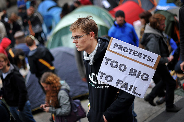 Occupy London protests: Oct 16: A protestor holds a placard outside St Paul's Cathedral 