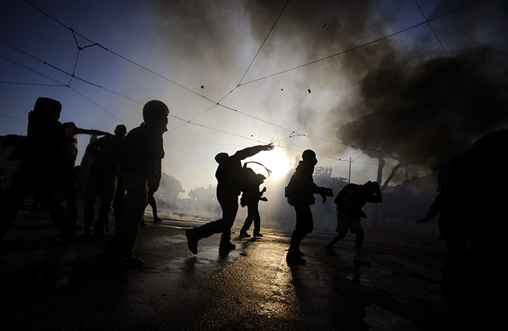 Occupy protests: Protestors attack a police vehicle during a demonstration in Rome