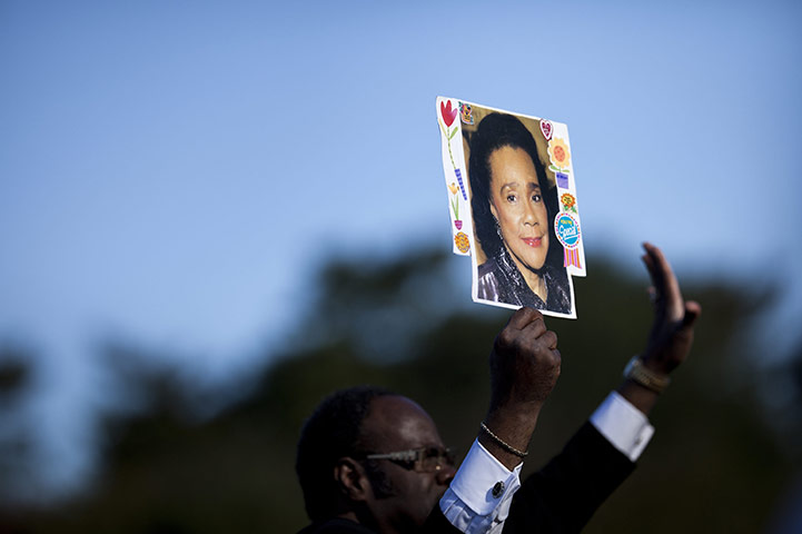 Martin Luther King: Rev. Cal  HP Merrell, of Atlanta, holds a photo of Coretta Scott King