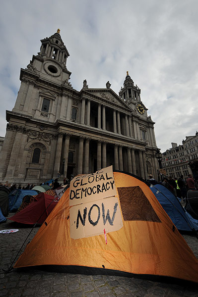Occupy London Protests: A placard is seen on a protestors tent with St Paul's in the background