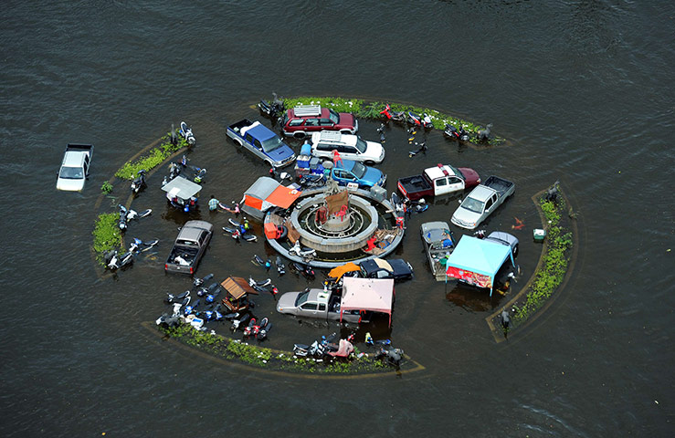 Thailand flooding: Partially-submerged vehicles are stranded at a roundabout in Ayutthaya