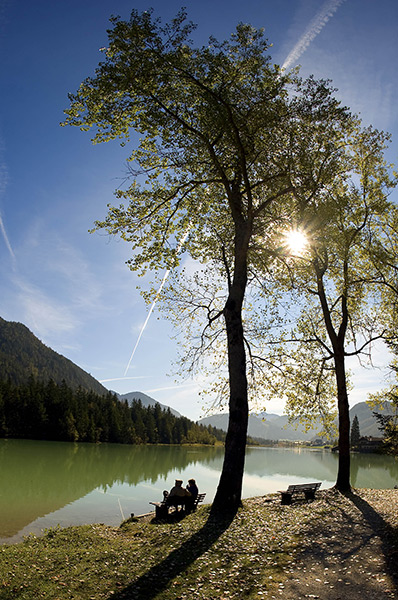 24 hours: Austria: Tourists sit on a bench at the waterside of Lake Pillersee