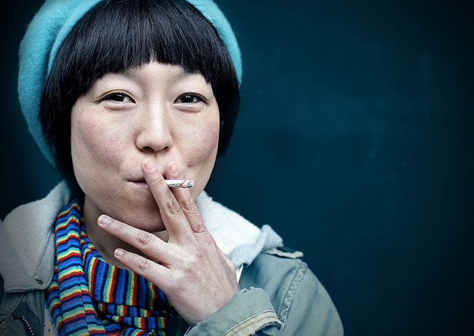 Pete Zelewski portfolio: Soho hairdresser Aki takes a break in Denmark Street, Soho, Central London