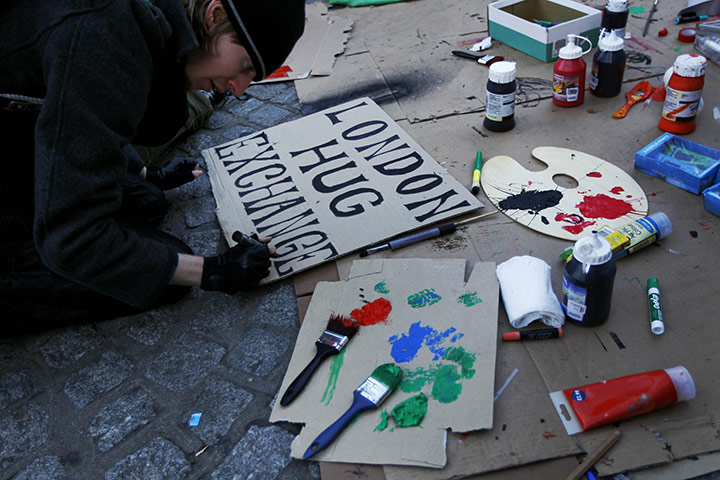 Occupy London: a protester puts the finishing touches to a placard
