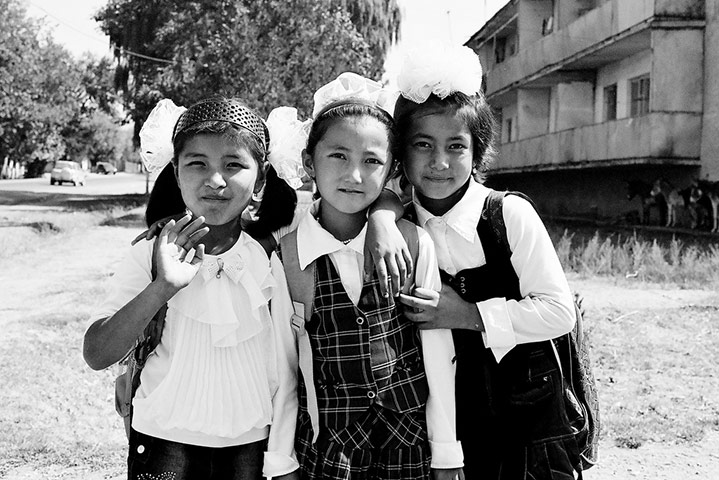 MarcinMonko assignment: School girls, main street in Karavan, Kyrgyzstan