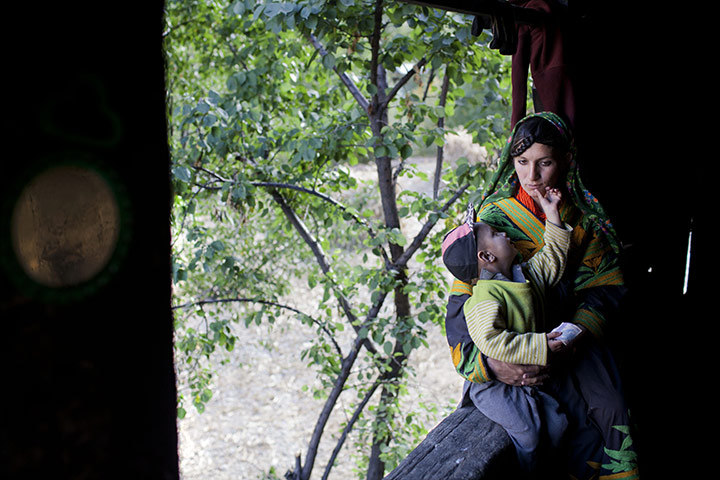 Kalash valley, Pakistan: Kalash mother and child at home in Bumburet