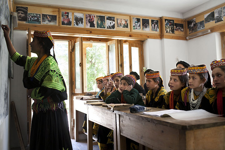 Kalash valley, Pakistan: Kalash girls practise the Kalasha language in a private school