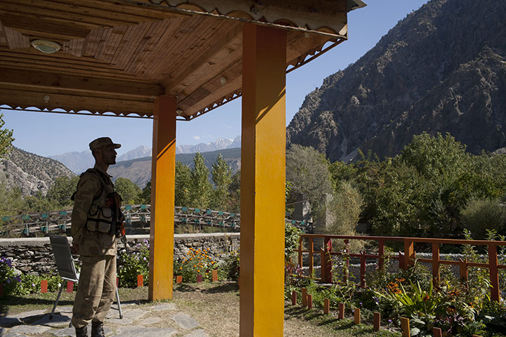 Kalash valley, Pakistan: An army soldier stands guard at an army outpost, Kalash valley