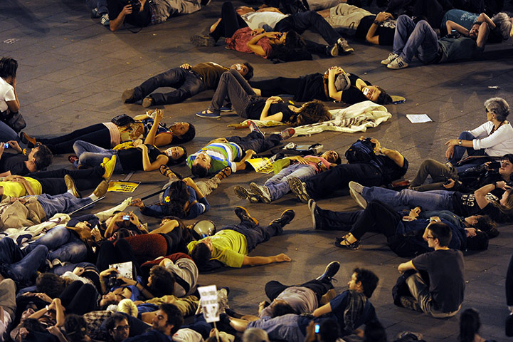 Occupy World Protests: Protesters lay on the street during at Puerta del Sol square in Madrid
