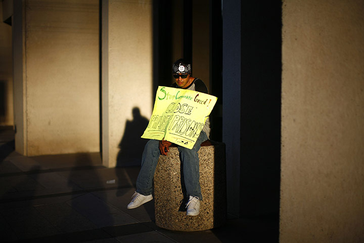 Occupy World Protests: A protester displays a placard Occupy Phoenix demonstration, Arizona