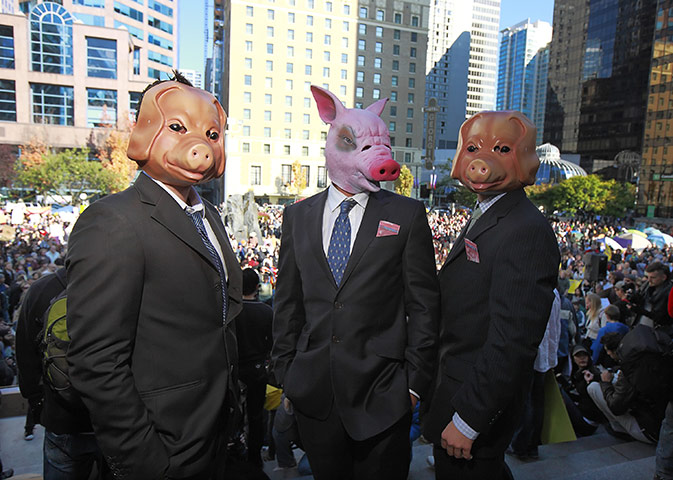 Occupy World Protests: Protesters wear pig masks and business suits, Occupy Vancover