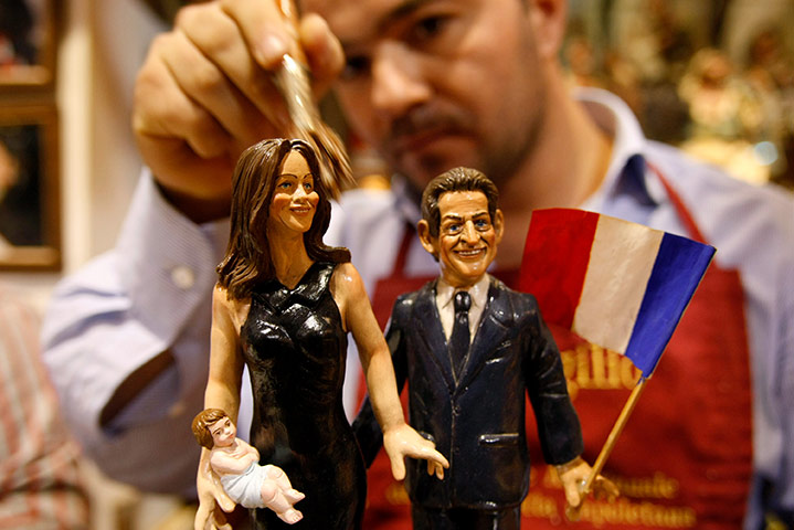 24 hours in pictures: Naples, Italy: An artist applies the finishing touches to figurines