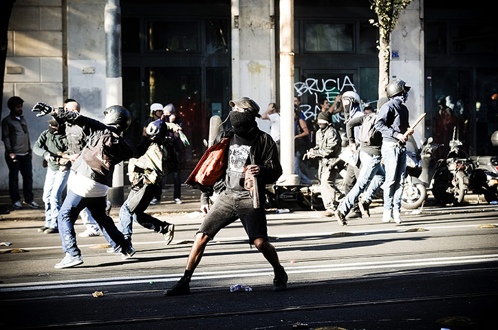 Occupy World Protests:  Demonstrators throw stones at a police truck, Rome