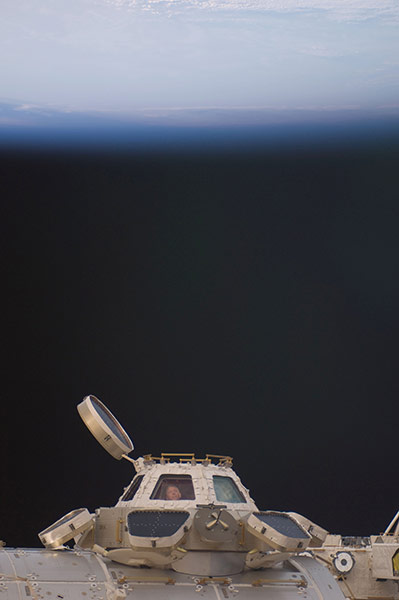 Month in space: Mike Fossum is pictured in a window of the Cupola of ISS