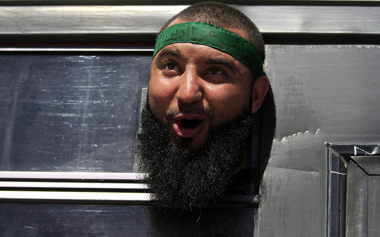 Shalit release: A Palestinian prisoner freed from an Israeli jail chants from a bus