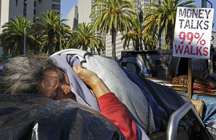 Occupy protests: An Occupy San Francisco protester sleeps in Justin Herman Plaza