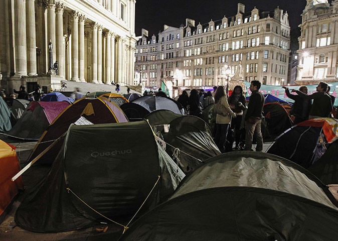 Occupy London protests: People stand among the tents of demonstrators outside St Paul's Cathedral 