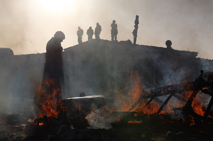 Dale Farm camp: A caravan is burnt down as activists stand nearby, Dale Farm