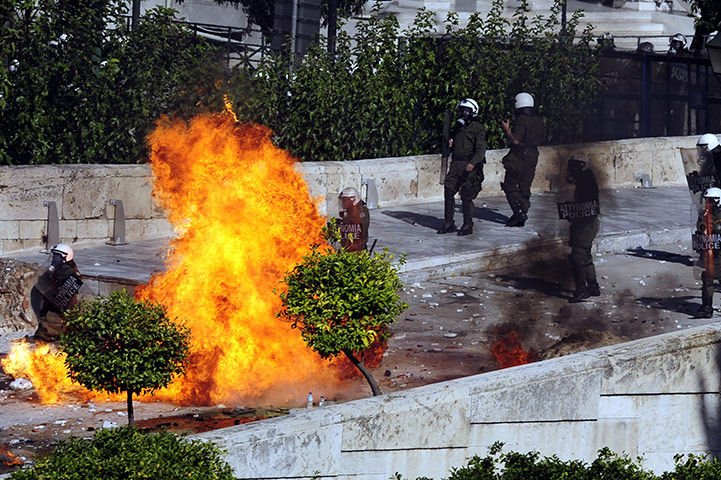 Greece strikes & protests: Protesters throw petrol bombs at riot police in front of Greek Parliament 